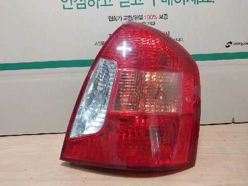 Used OEM Part - Tail light assembly compatible with Hyundai Accent 2007, genuine OEM replacement part 92402 1E000